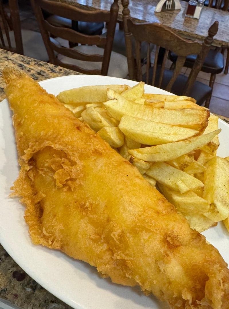 Cod and chips on a plate at Reliance Fish Restaurant